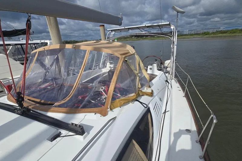 Slide: The Image of 2011 Jeanneau Sun Odyssey 50 DS sailboat with cockpit cover on calm water. - 21