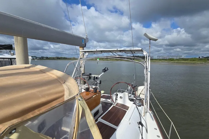 Slide: The Image of 2011 Jeanneau Sun Odyssey 50 DS sailboat on calm river under cloudy sky. - 22