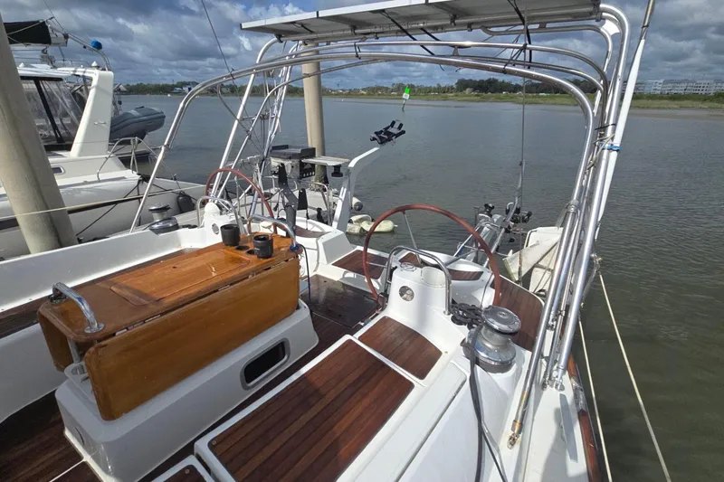 Slide: The Image of 2011 Jeanneau Sun Odyssey 50 DS sailboat cockpit with wooden accents and dual steering wheels. - 23