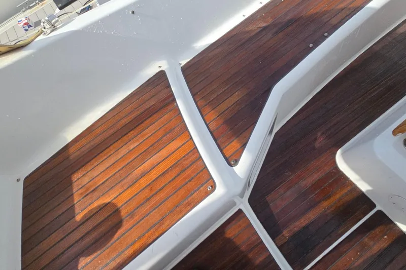 Slide: The Image of Teak deck of 2011 Jeanneau Sun Odyssey 50 DS sailboat, showcasing elegant wood finish. - 27