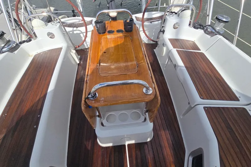 Slide: The Image of Cockpit of 2011 Jeanneau Sun Odyssey 50 DS with wooden seating and steering wheels. - 28