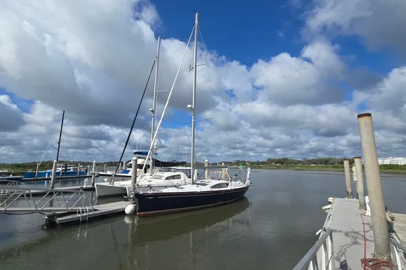 Slide: The Image of Jeanneau Sun Odyssey 50 DS 2011 sailboat docked under a partly cloudy sky. - 3