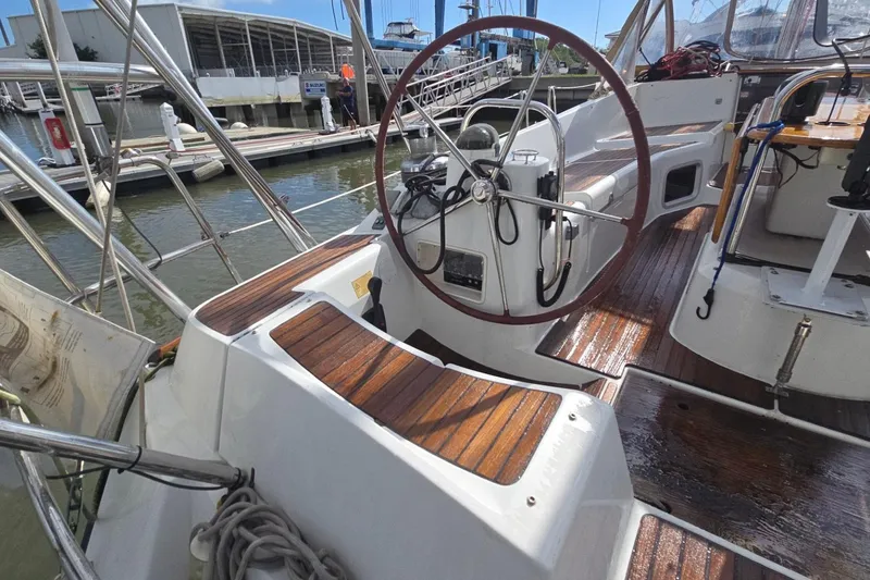 Slide: The Image of Cockpit of 2011 Jeanneau Sun Odyssey 50 DS sailboat with wooden deck and steering wheel. - 33