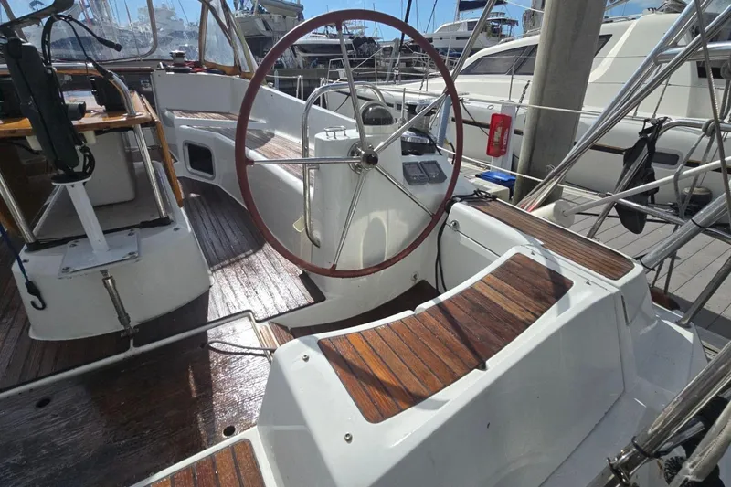 Slide: The Image of Cockpit of 2011 Jeanneau Sun Odyssey 50 DS with wooden seating and steering wheel. - 34