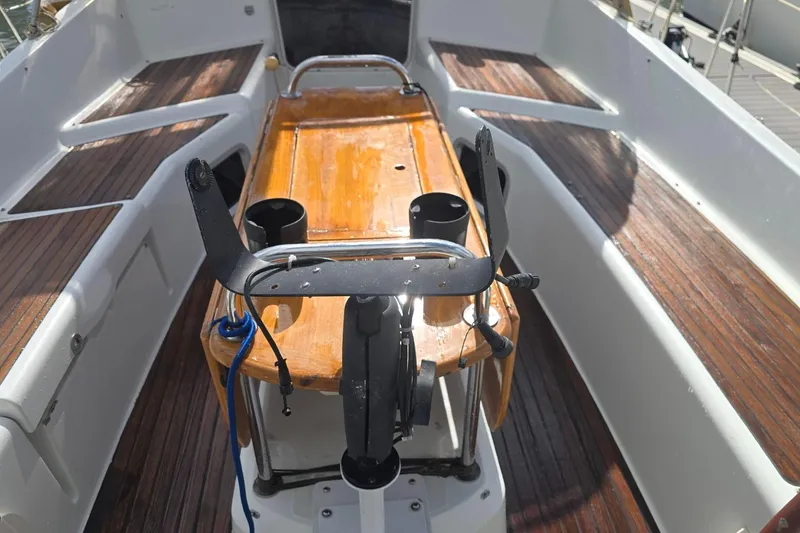 Slide: The Image of Cockpit of 2011 Jeanneau Sun Odyssey 50 DS with wooden table and steering wheel. - 37