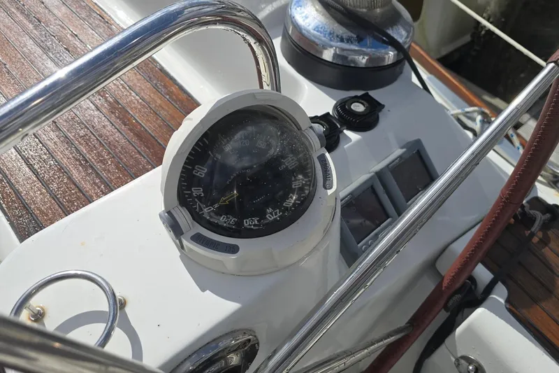 Slide: The Image of Compass and controls on 2011 Jeanneau Sun Odyssey 50 DS yacht deck. - 38