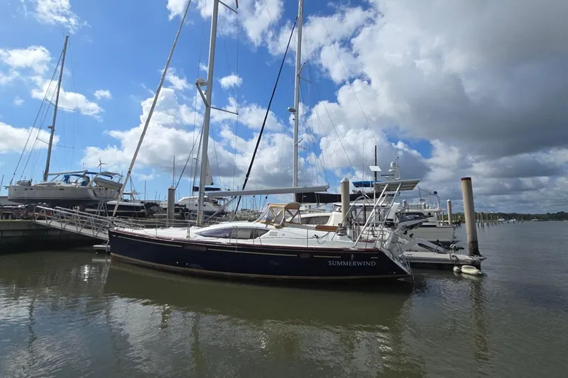 Slide: The Image of Jeanneau Sun Odyssey 50 DS 2011 sailboat docked under a partly cloudy sky. - 4