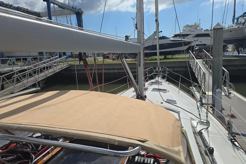 Slide: The Image of 2011 Jeanneau Sun Odyssey 50 DS sailboat docked at a marina under a clear sky. - 41