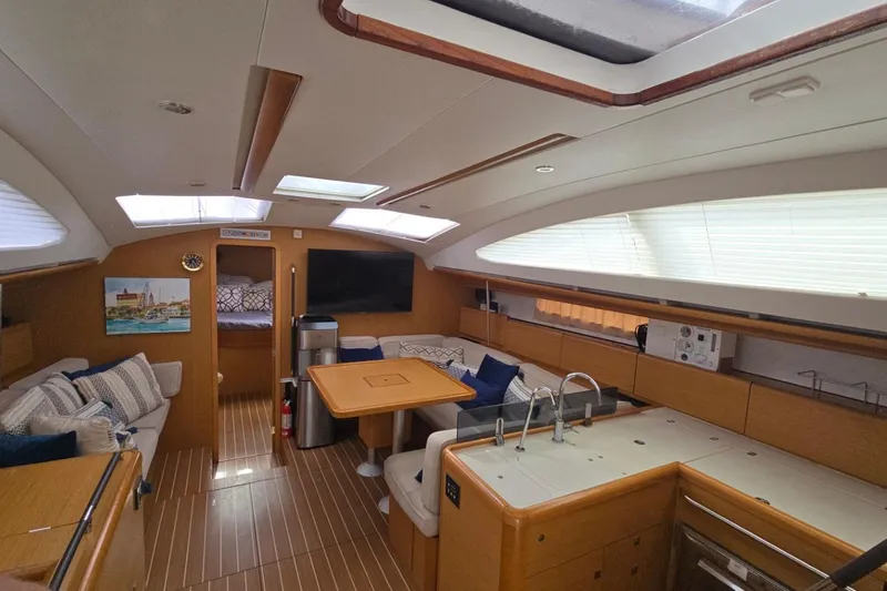 Slide: The Image of Interior of 2011 Jeanneau Sun Odyssey 50 DS yacht with modern kitchen and cozy seating area. - 50