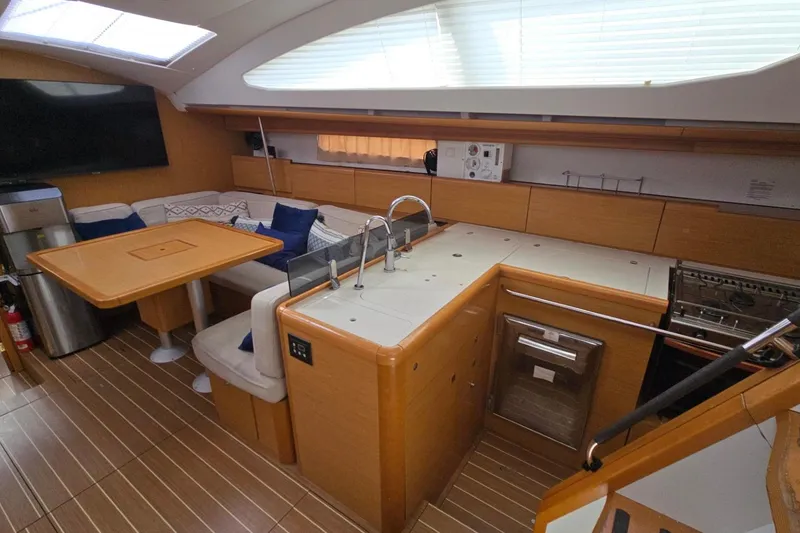 Slide: The Image of Interior of 2011 Jeanneau Sun Odyssey 50 DS yacht with modern kitchen and seating area. - 51