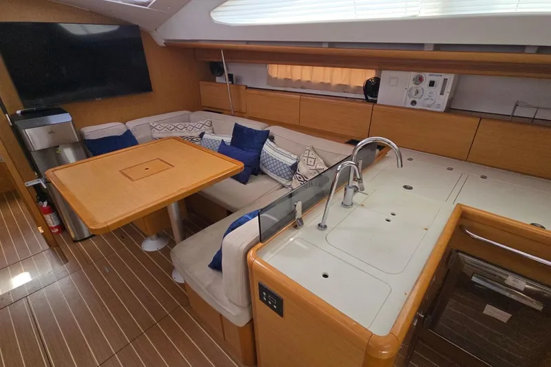 Slide: The Image of Interior of 2011 Jeanneau Sun Odyssey 50 DS yacht with modern kitchen and seating area. - 54