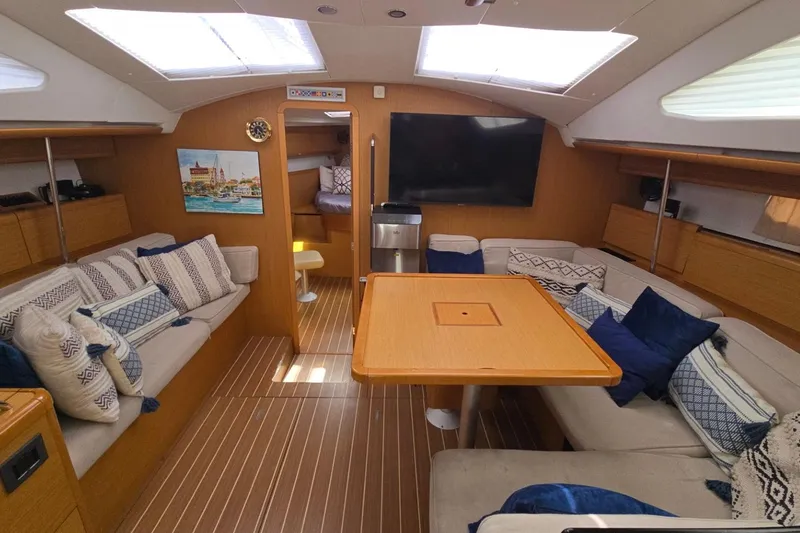 Slide: The Image of Interior of 2011 Jeanneau Sun Odyssey 50 DS yacht with cozy seating and wooden table. - 55