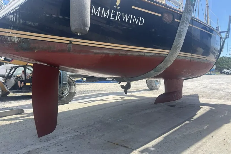 Slide: The Image of 2011 Jeanneau Sun Odyssey 50 DS sailboat on dry dock, showing hull and keel. - 6