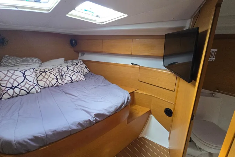 Slide: The Image of Cozy cabin interior of 2011 Jeanneau Sun Odyssey 50 DS with bed and TV. - 62