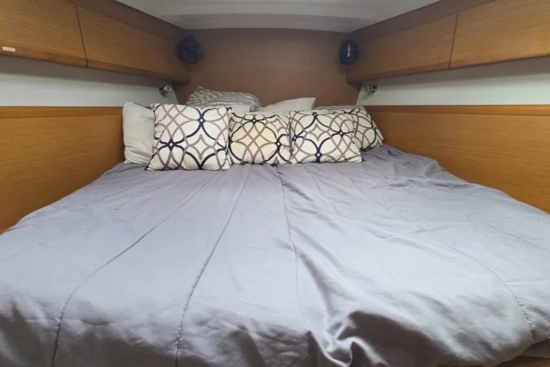 Slide: The Image of Cozy cabin bed with patterned pillows in 2011 Jeanneau Sun Odyssey 50 DS yacht. - 63