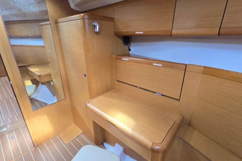 Slide: The Image of Interior of 2011 Jeanneau Sun Odyssey 50 DS yacht with wooden cabinetry and seating. - 65