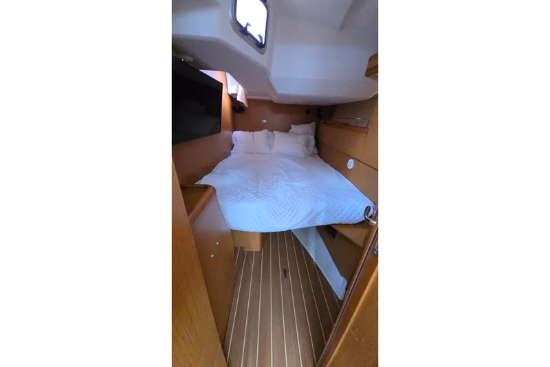 Slide: The Image of Cozy cabin interior of 2011 Jeanneau Sun Odyssey 50 DS sailboat with bed and wooden finish. - 73