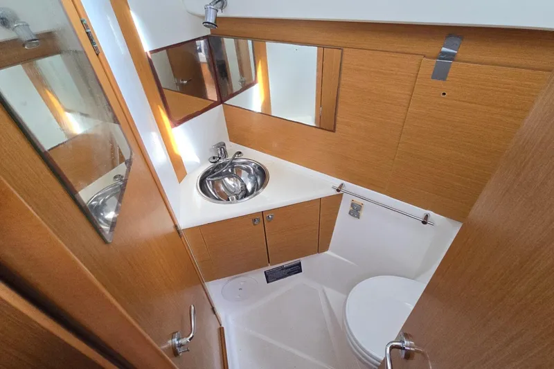 Slide: The Image of Bathroom interior of 2011 Jeanneau Sun Odyssey 50 DS yacht, featuring sink and toilet. - 76