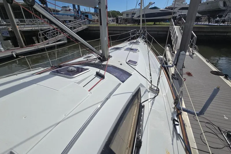 Slide: The Image of 2011 Jeanneau Sun Odyssey 50 DS sailboat docked at marina, showcasing deck and rigging. - 9