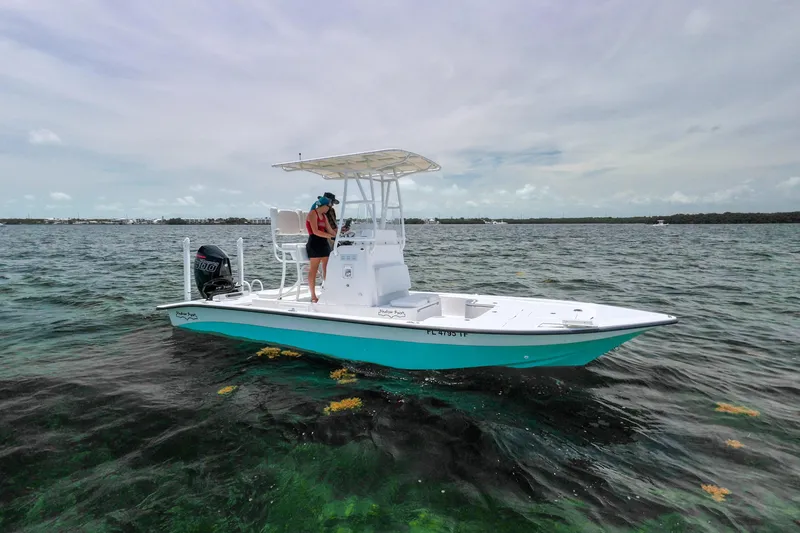 The Image of 2022 Shallow Sport 24 Modified V boat on clear water with a person onboard. - 0