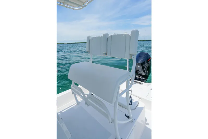 Slide: The Image of 2022 Shallow Sport 24 Modified V boat with seating and outboard motor on open water. - 10