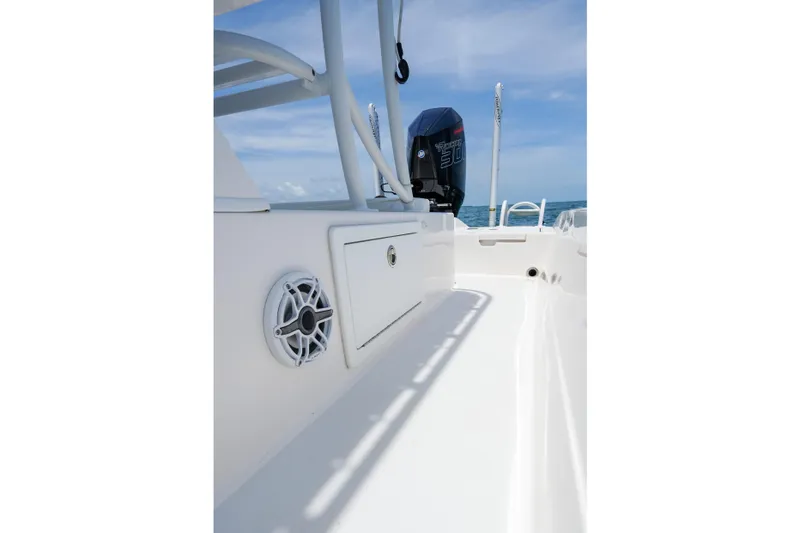 Slide: The Image of 2022 Shallow Sport 24 Modified V boat with outboard motor on open water. - 11