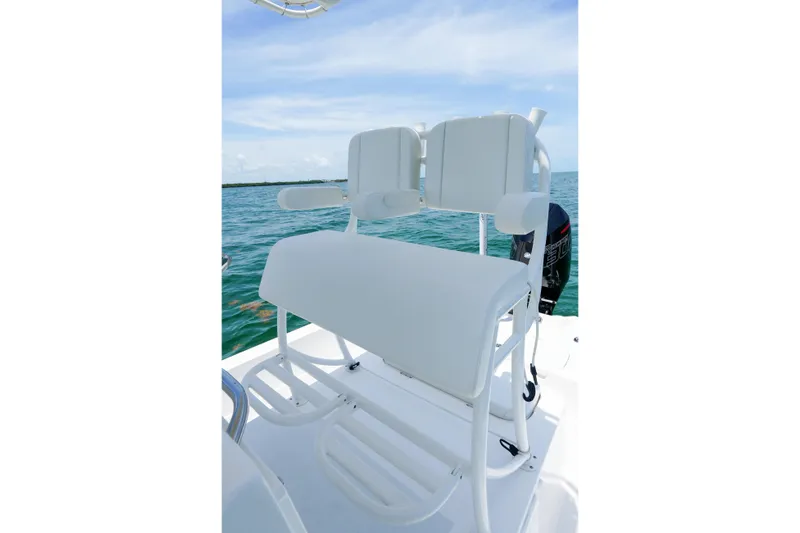 Slide: The Image of 2022 Shallow Sport 24 Modified V boat seating on open water. - 12