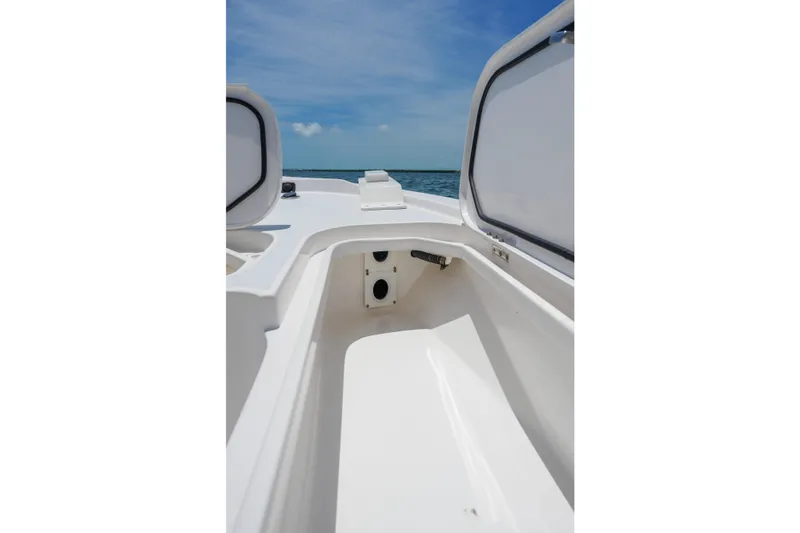 Slide: The Image of 2022 Shallow Sport 24 Modified V boat interior with open storage compartments. - 17