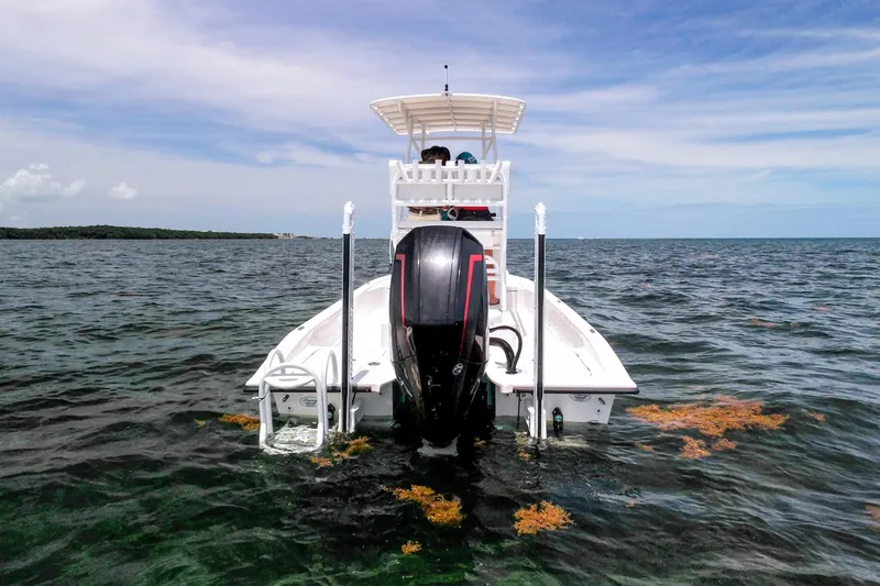 Slide: The Image of 2022 Shallow Sport 24 Modified V boat on open water, rear view. - 3