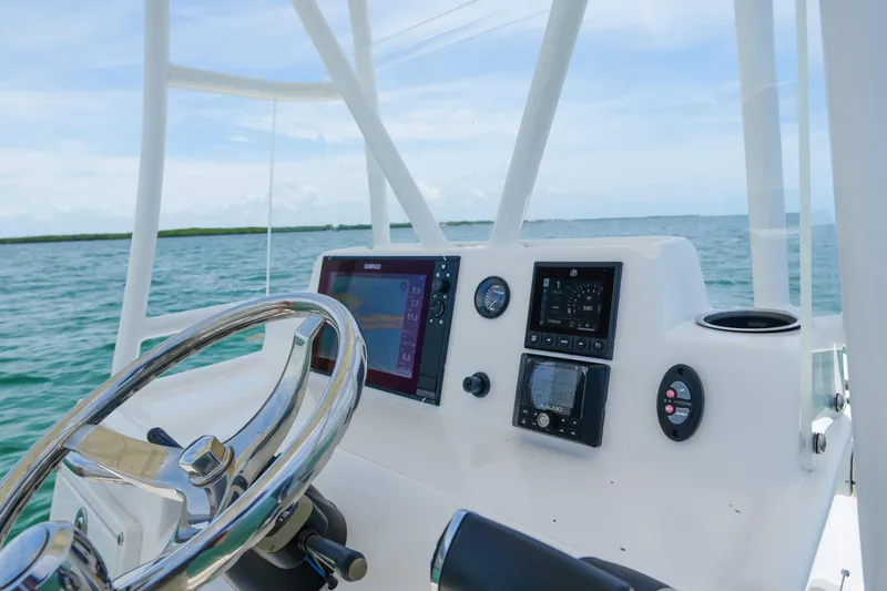 Slide: The Image of 2022 Shallow Sport 24 Modified V boat dashboard with navigation equipment on open water. - 5