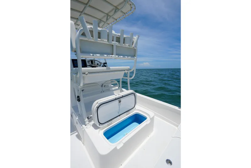 Slide: The Image of 2022 Shallow Sport 24 Modified V boat with open storage compartment on the ocean. - 7