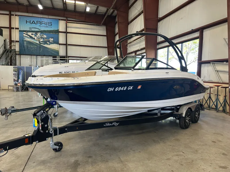 The Image of 2023 Sea Ray SPX 210 boat in warehouse on trailer. - 0