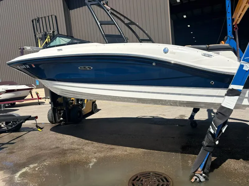 Slide: The Image of 2023 Sea Ray SPX 210 boat on a trailer outdoors. - 2