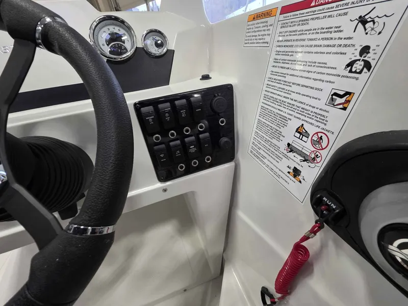 Slide: The Image of Starcraft SVX 171 OB 2026 boat console with controls and safety warnings. - 13
