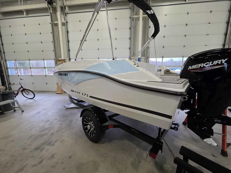 Slide: The Image of Starcraft SVX 171 OB 2026 boat in garage with Mercury engine. - 5