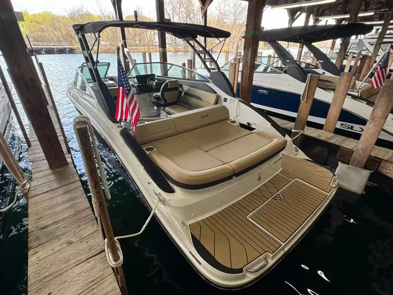 Slide: The Image of 2026 Sea Ray SLX 260 boat docked in marina. - 2