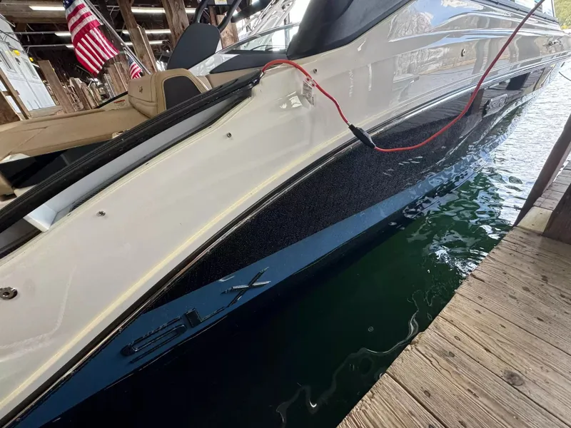 Slide: The Image of 2026 Sea Ray SLX 260 boat docked with American flags. - 3