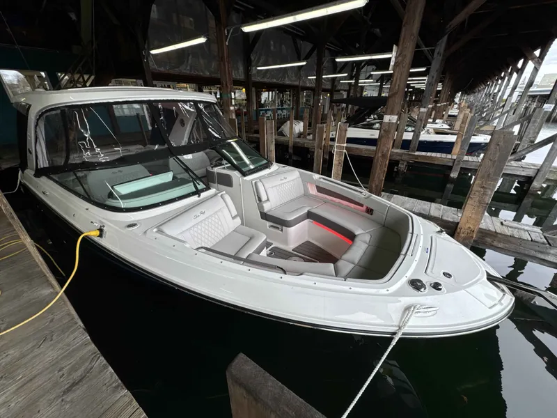 The Image of 2026 Sea Ray SLX 310 boat docked in marina. - 1
