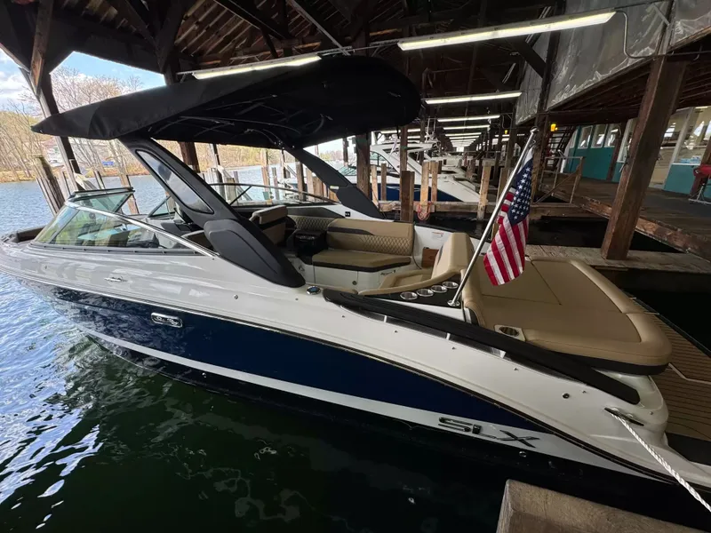 The Image of 2026 Sea Ray 280SLX boat docked with American flag. - 1