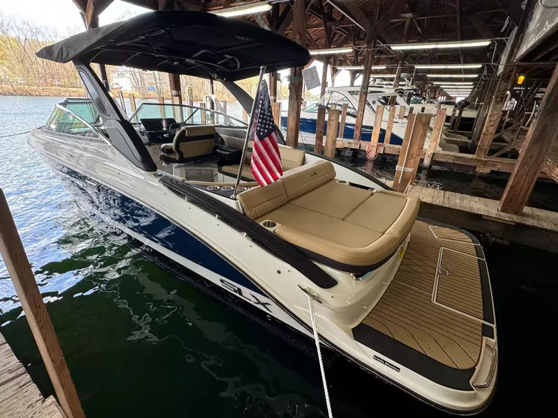 Slide: The Image of 2026 Sea Ray 280SLX boat docked with American flag. - 3