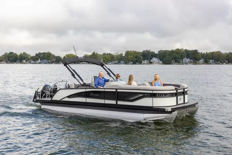 The Image of Barletta Corsa 23UC 2026 pontoon boat on a serene lake. - 1