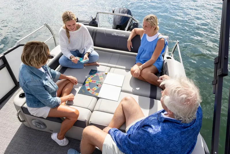 Slide: The Image of Family playing board game on Barletta Corsa 23UC boat, 2026 model. - 4