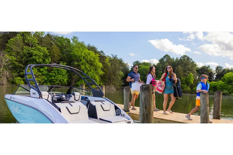 Slide: The Image of Family boarding Yamaha 222S boat at lakeside dock. - 8