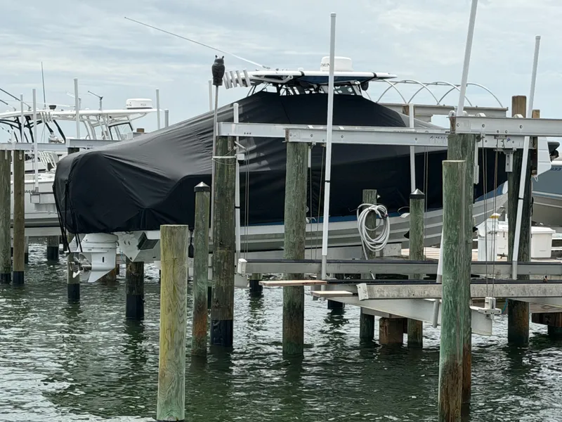 Slide: The Image of 2024 Sportsman Open 252 Center Console on boat lift at marina. - 10