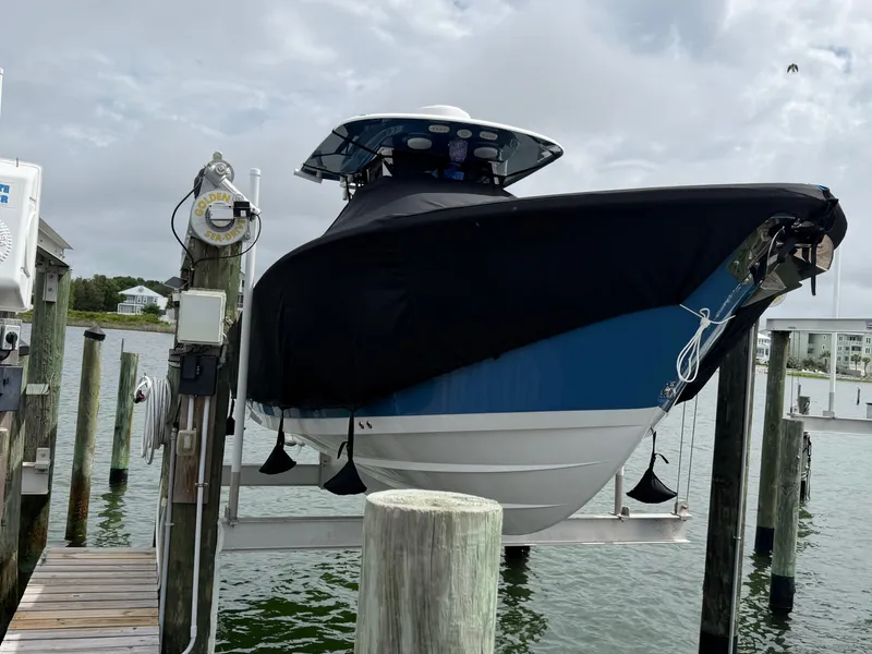 Slide: The Image of 2024 Sportsman Open 252 Center Console on boat lift at dock. - 11