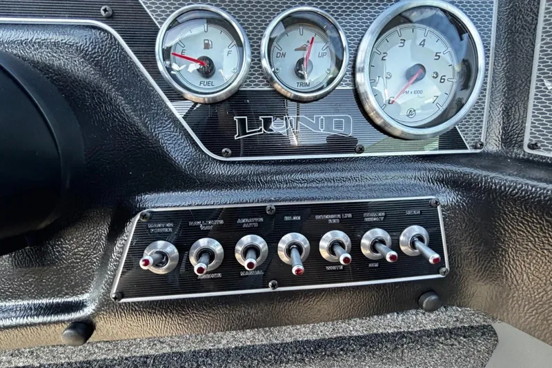 Slide: The Image of Dashboard of 2026 Lund 1875 Crossover XS with gauges and toggle switches. - 13