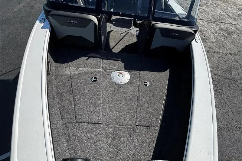 Slide: The Image of 2026 Lund 1875 Crossover XS boat interior with seating and carpeted deck. - 14