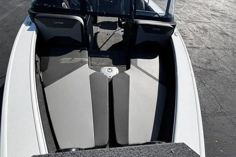 Slide: The Image of 2026 Lund 1875 Crossover XS boat interior with seating and windshield. - 15