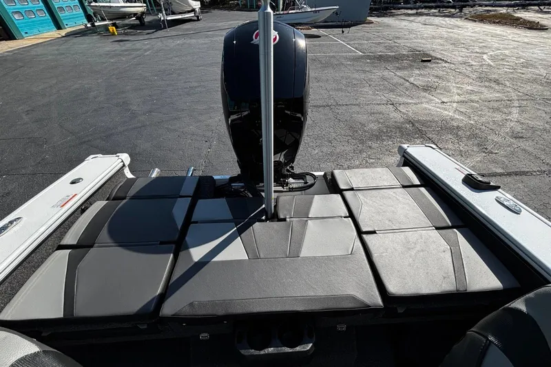 Slide: The Image of 2026 Lund 1875 Crossover XS boat with sleek seating and powerful outboard motor. - 7