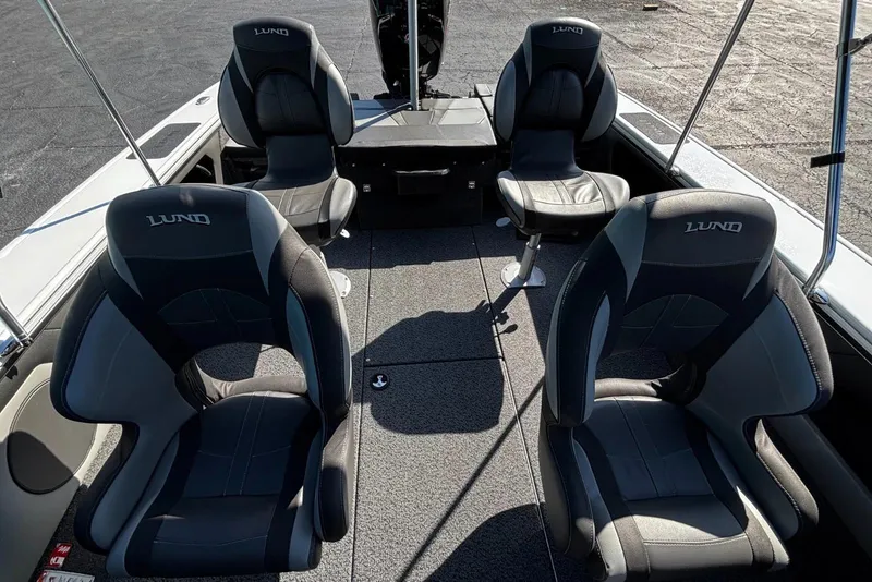 Slide: The Image of 2026 Lund 1875 Crossover XS boat interior with four black seats. - 8